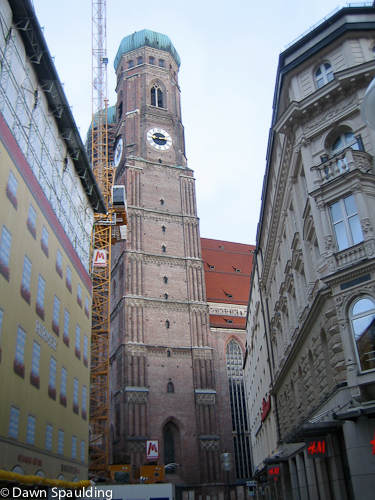 The cathedral is surrounded by buildings.